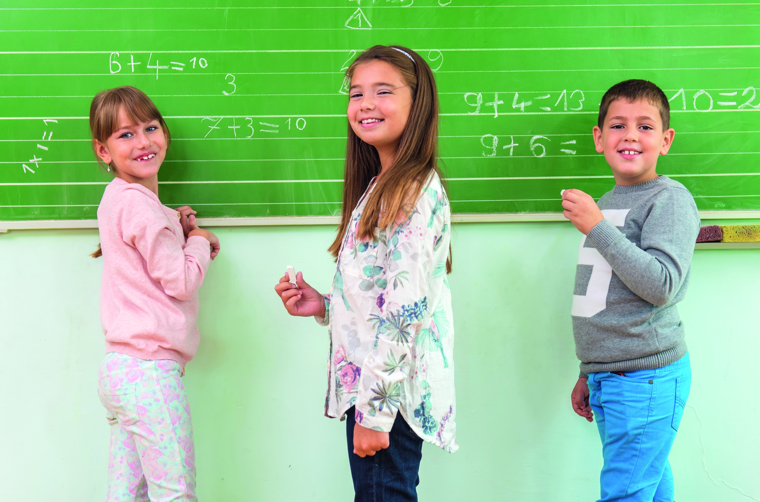 Teacher and student at the blackboard, math class