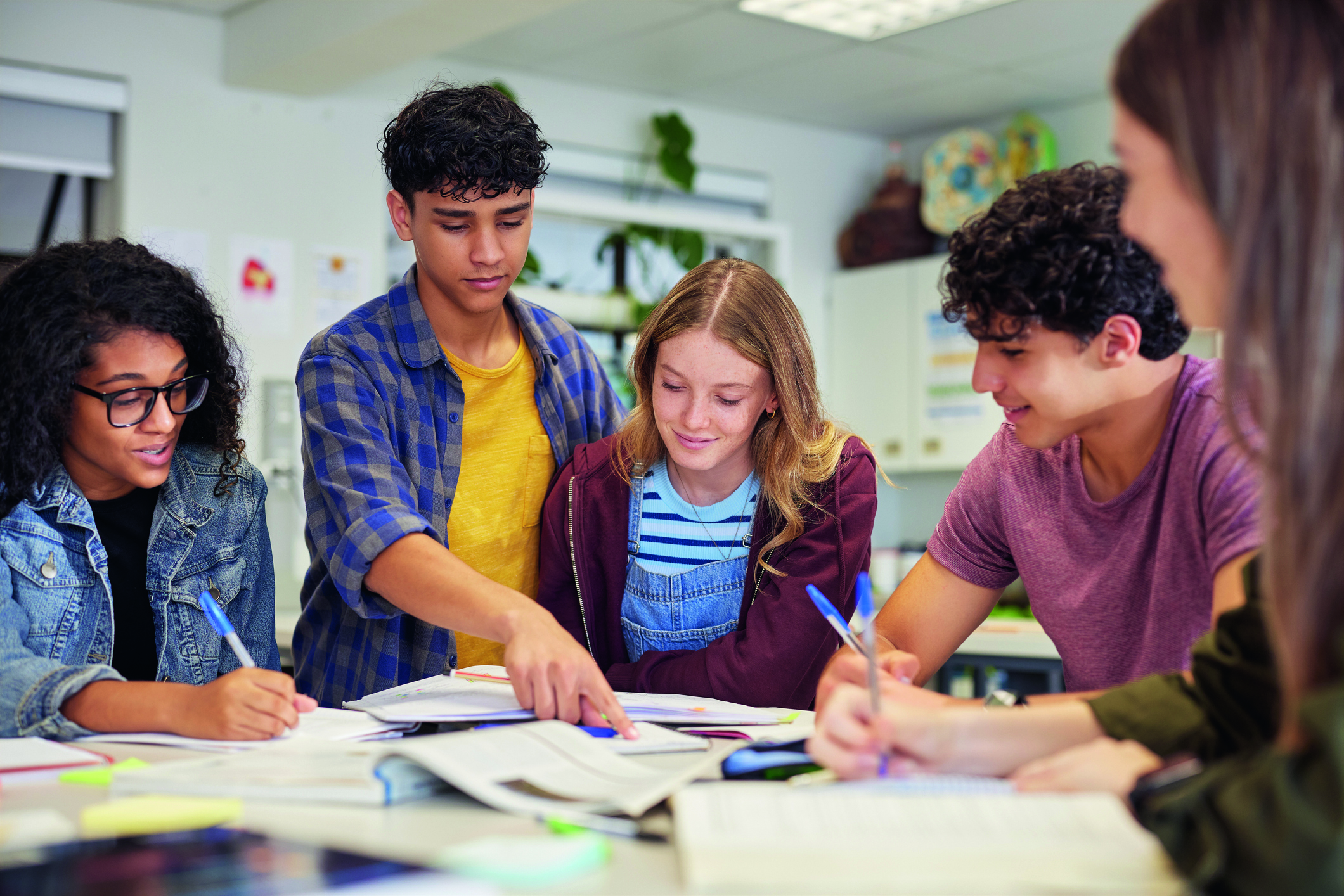 Multiethnic students studying together at secondary school